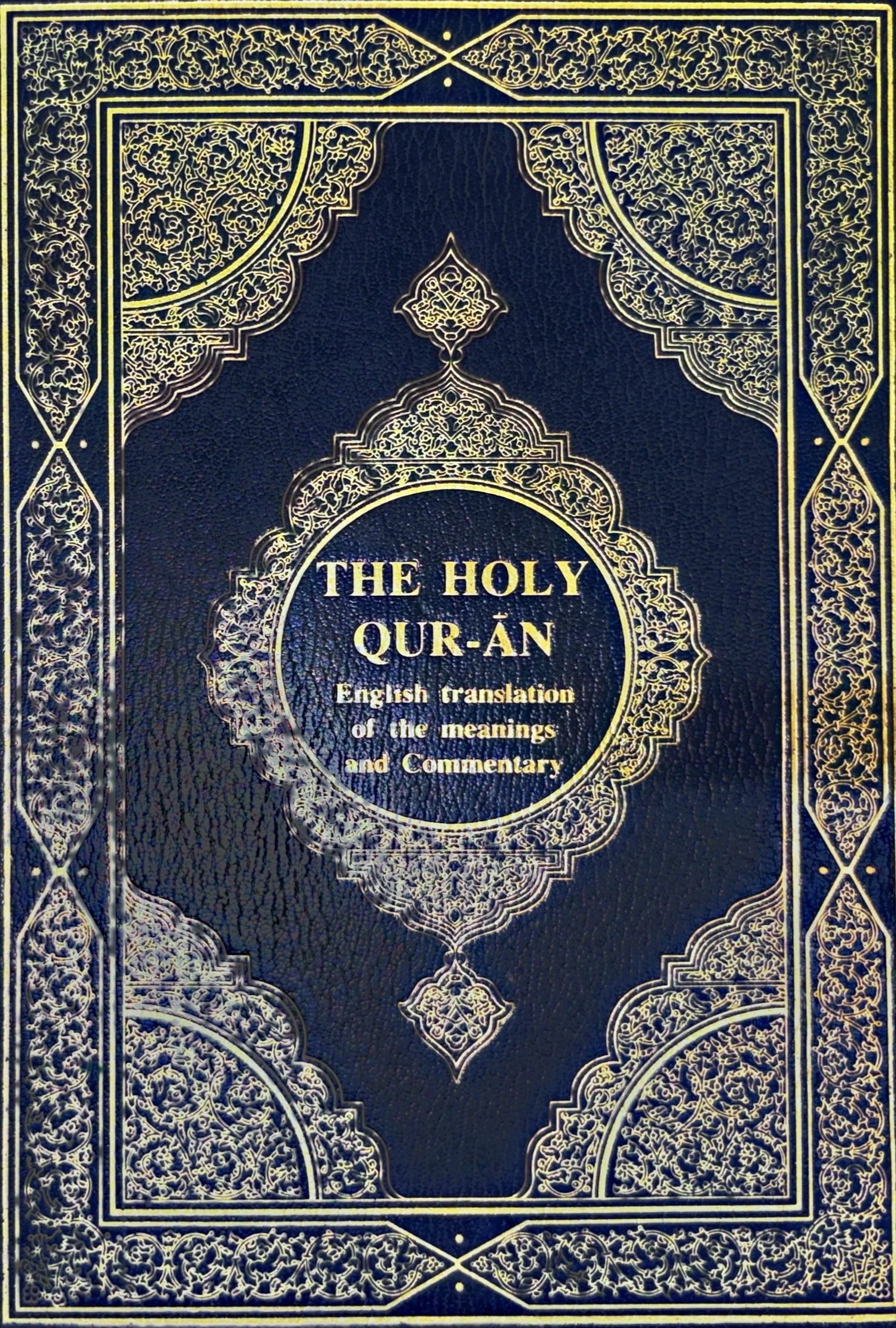 Front cover: The Holy Qur-ān, English translation of the meanings and Commentary